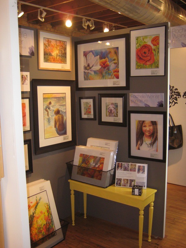 Right side of gallery booth with framed watercolor paintings