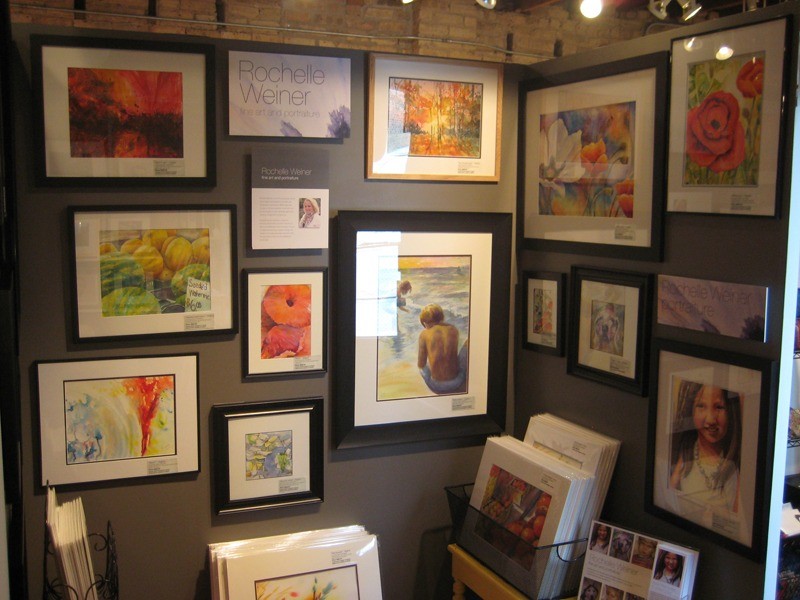 Left side of gallery booth with framed watercolor paintings